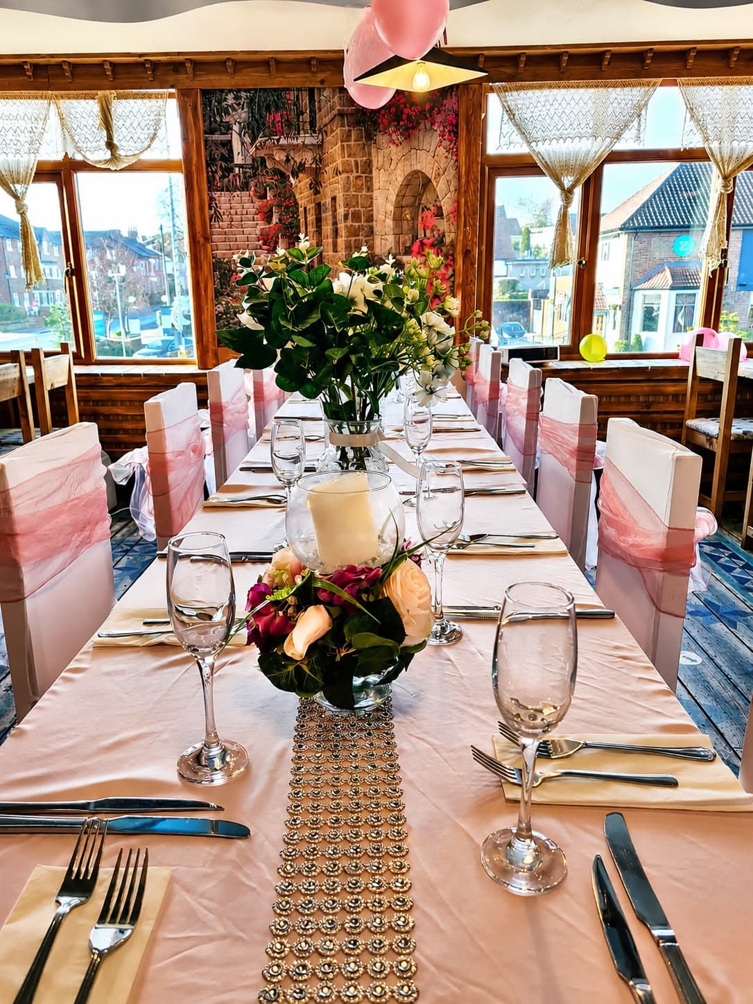 Table setting with candle and rose centrepiece
